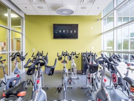 Wall Mounted TV and Exercise Bikes